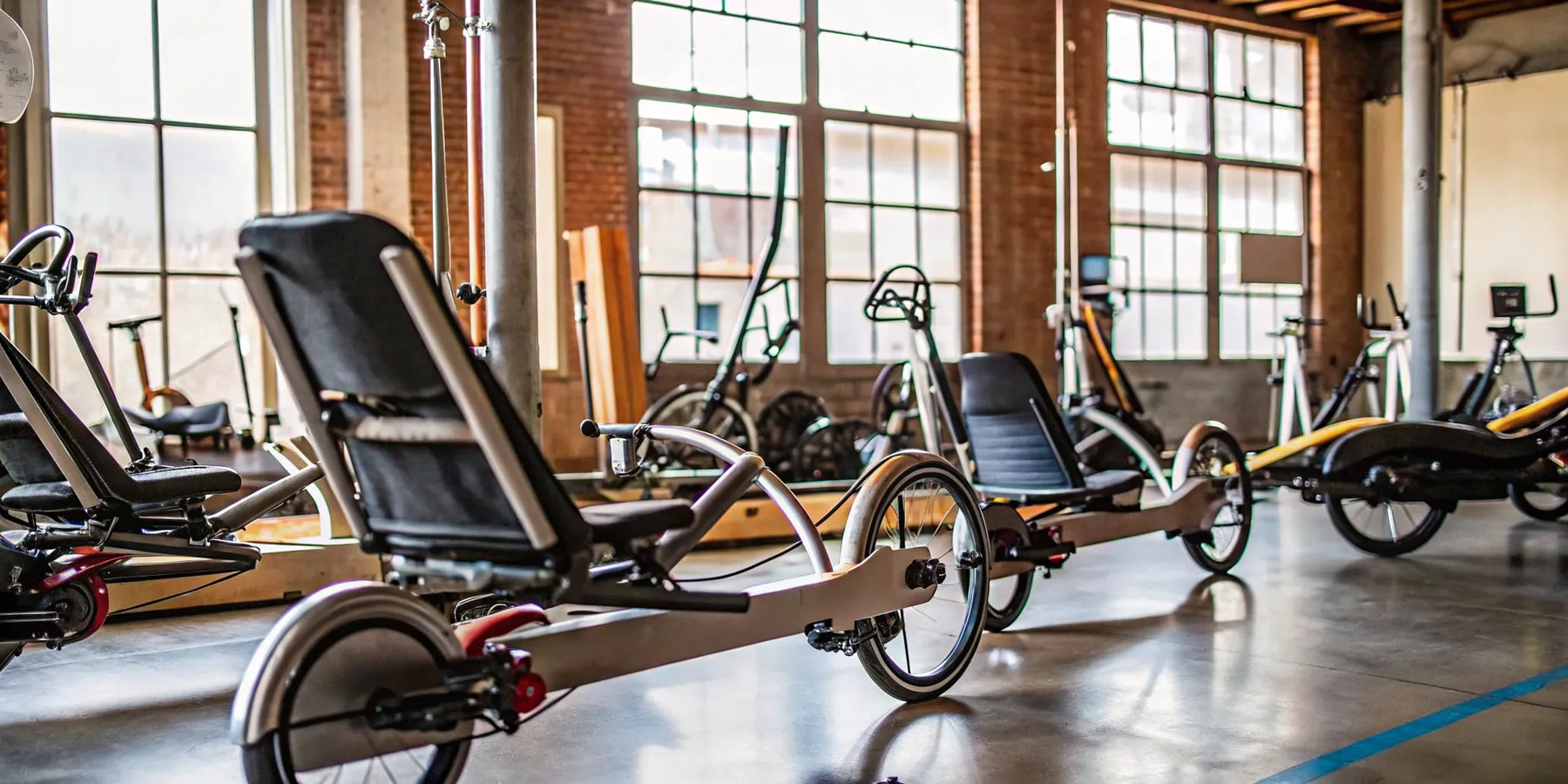 Two wheel electric recumbent bikes for sale in a showroom.