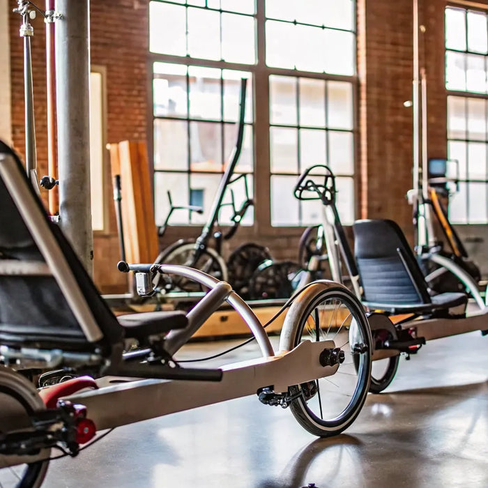 Two wheel electric recumbent bikes for sale in a showroom.