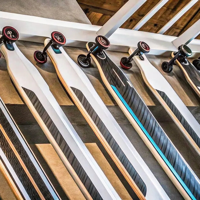 A selection of the best electric longboards for adults, featuring various models and deck styles.