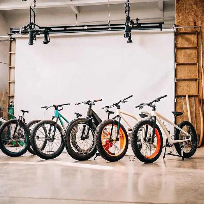 A lineup of the best fat tire ebikes for adults with sturdy frames in a showroom.