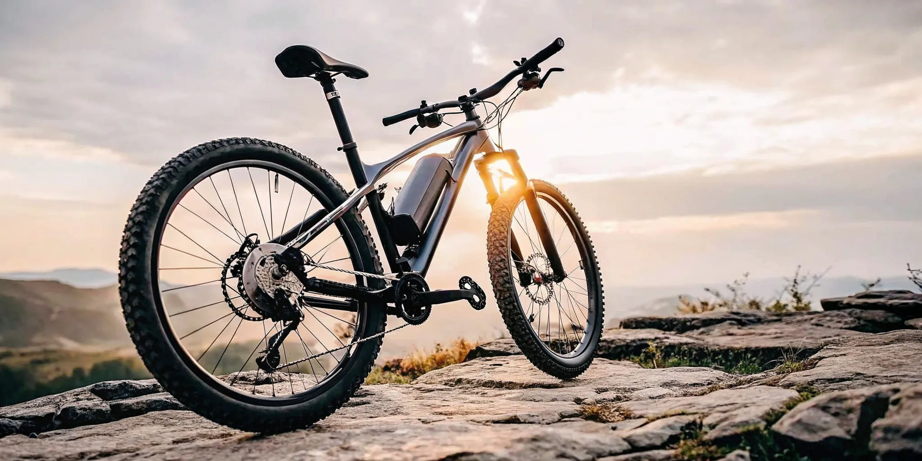 The best 1000 watt electric bike for power and range, shown on a rugged, rocky trail at sunset.