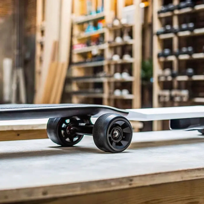One of the best budget electric skateboards on a wooden workbench.