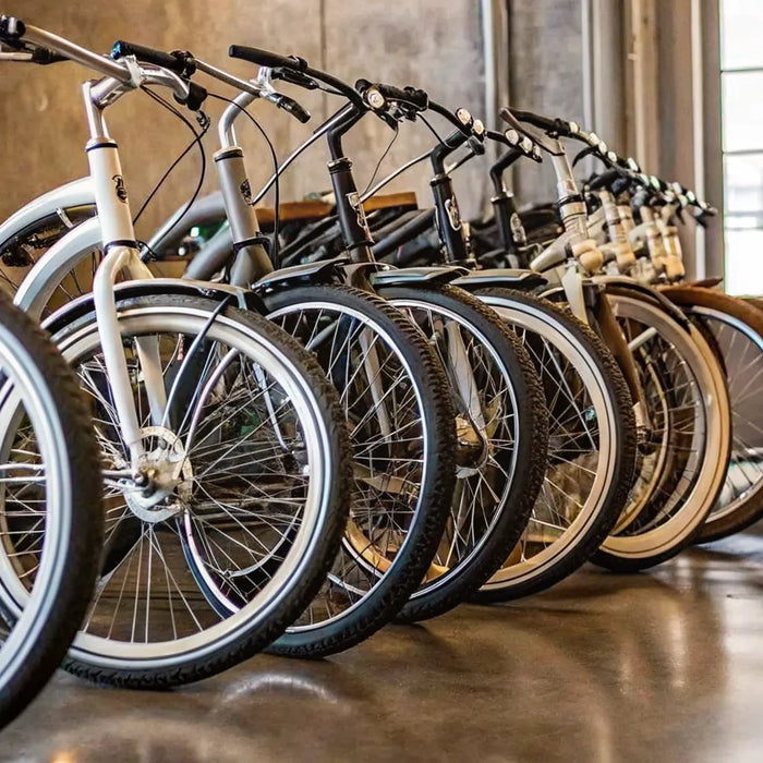 A lineup of cruiser ebike models with comfortable seats and wide tires in a bike shop.