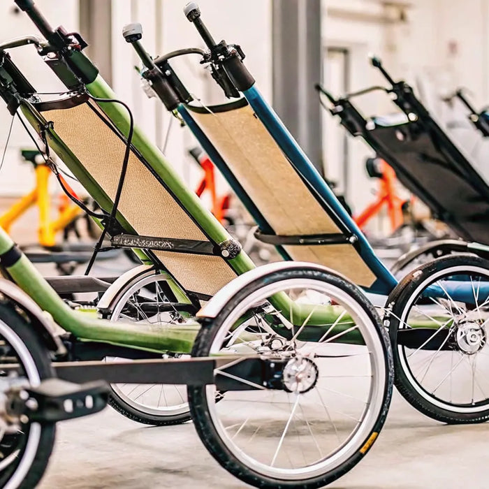 A row of the best electric recumbent trikes for seniors in a showroom.