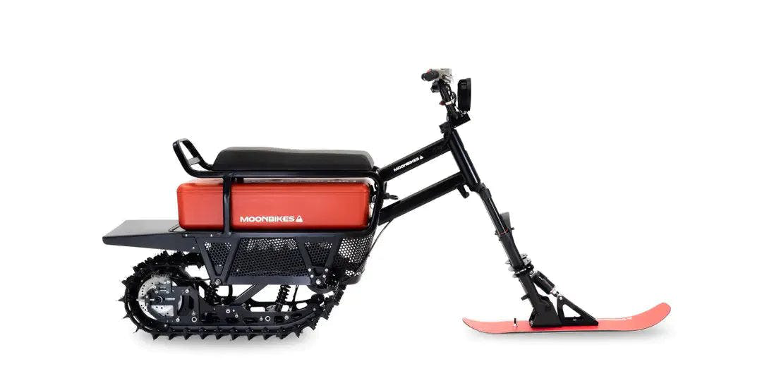 A MoonBike e-snowmobile in red