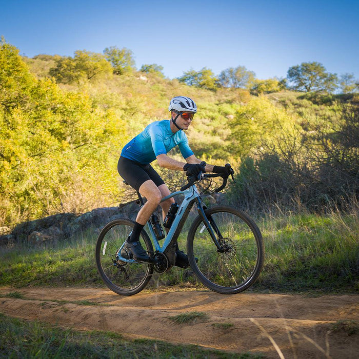 A cyclist riding a bike in the forest