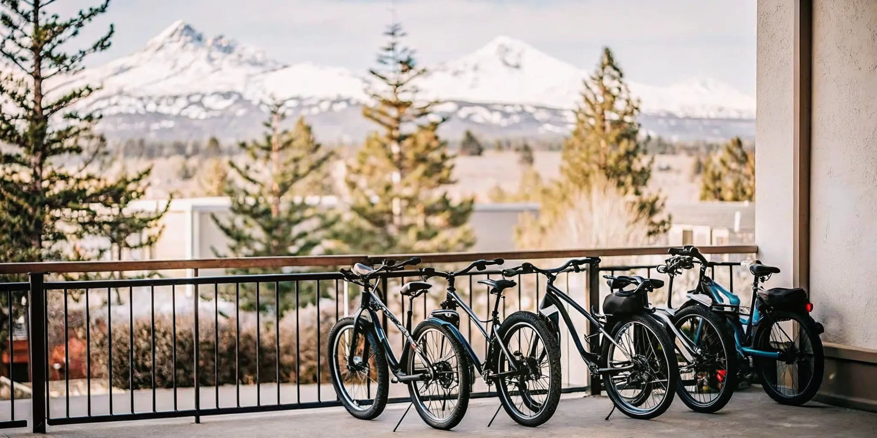 Electric bikes parked outside a shop in Bend Oregon with Cascade mountains in background