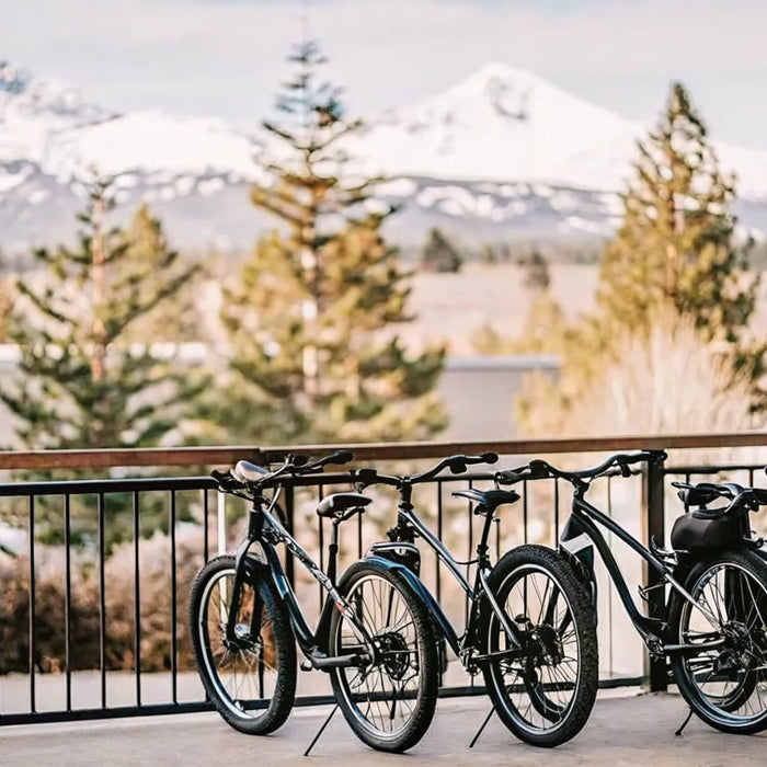 Electric bikes parked outside a shop in Bend Oregon with Cascade mountains in background