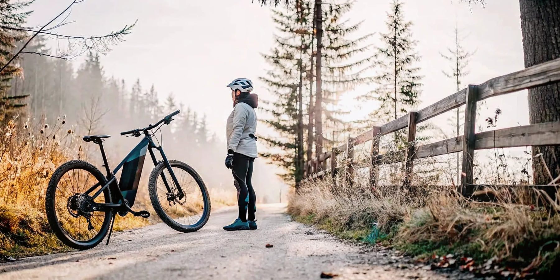 A rider with an electric mountain bike on a trail where rules determine if e-bikes can be ridden.