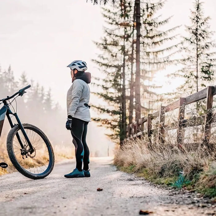 A rider with an electric mountain bike on a trail where rules determine if e-bikes can be ridden.