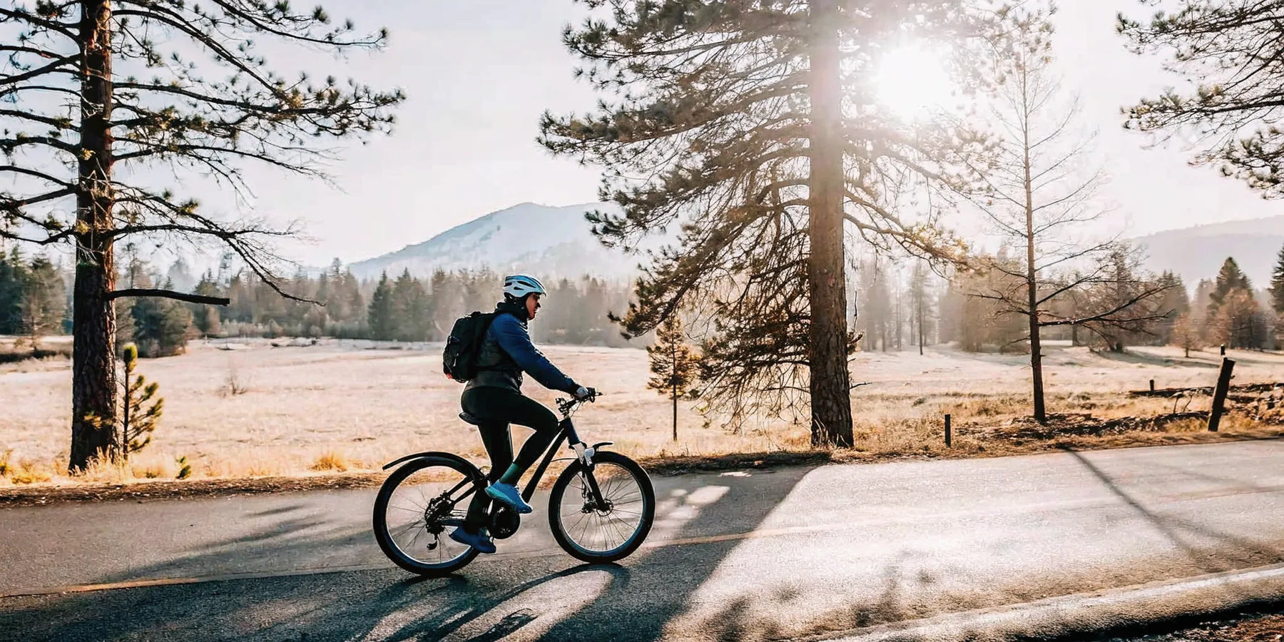 E-bike rider on a paved trail through Central Oregon pine forest
