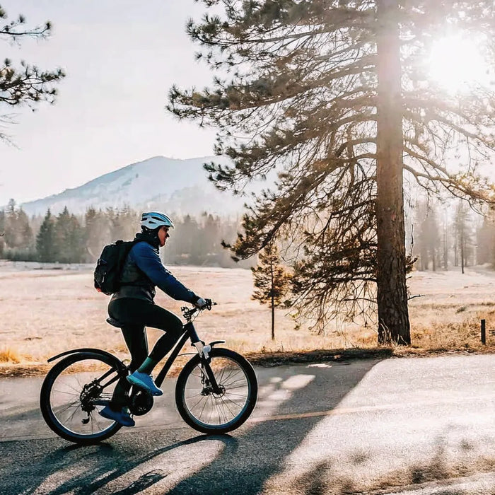 E-bike rider on a paved trail through Central Oregon pine forest