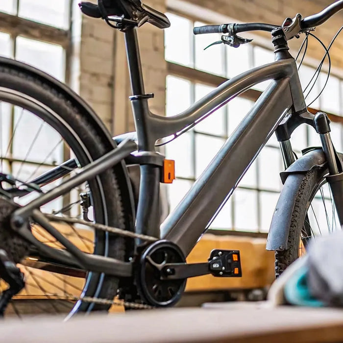 E-bike receiving routine maintenance and service in a workshop to keep it running reliably.