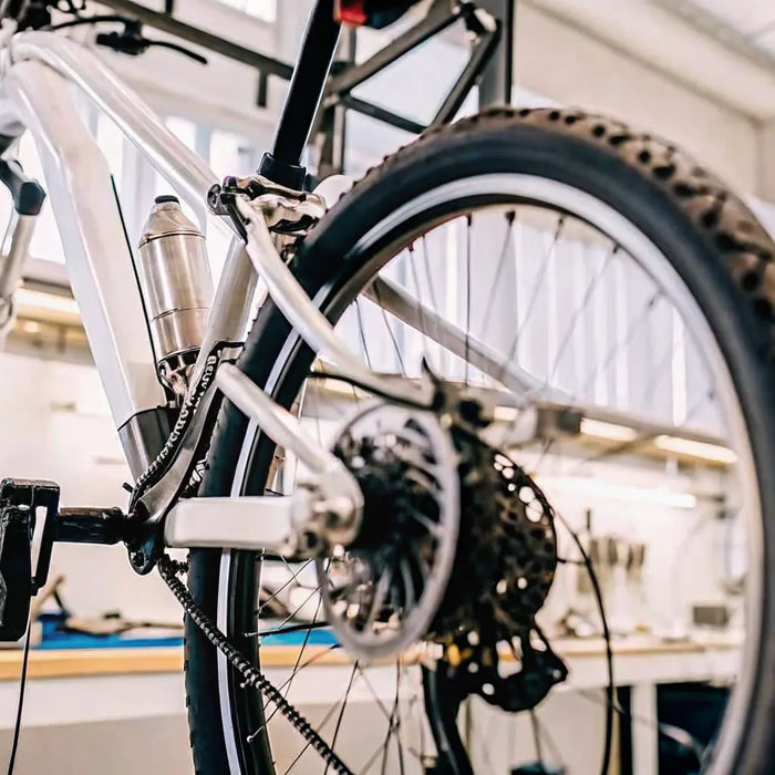 Technician inspecting an electric bike in a workshop