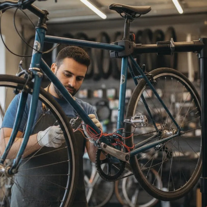 Technician examining electric bike controller wiring during diagnosis