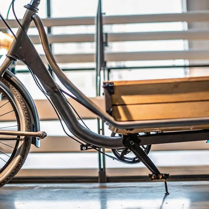 An electric front load cargo bike with a large wooden box.