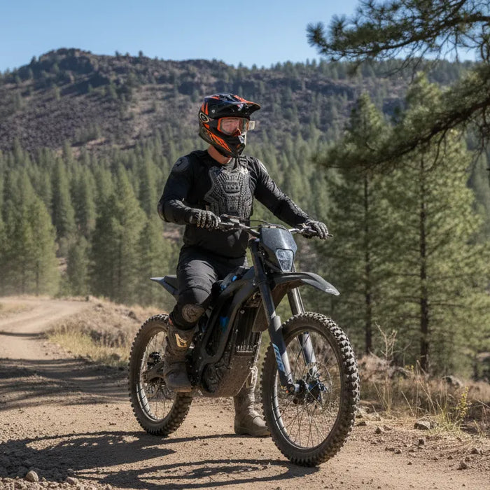 Electric dirt bike rider beside a Central Oregon trail