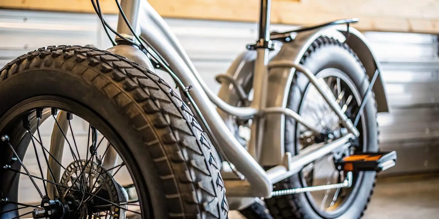 Electric fat tire tricycle for adults with thick all-terrain tires and a sturdy frame.