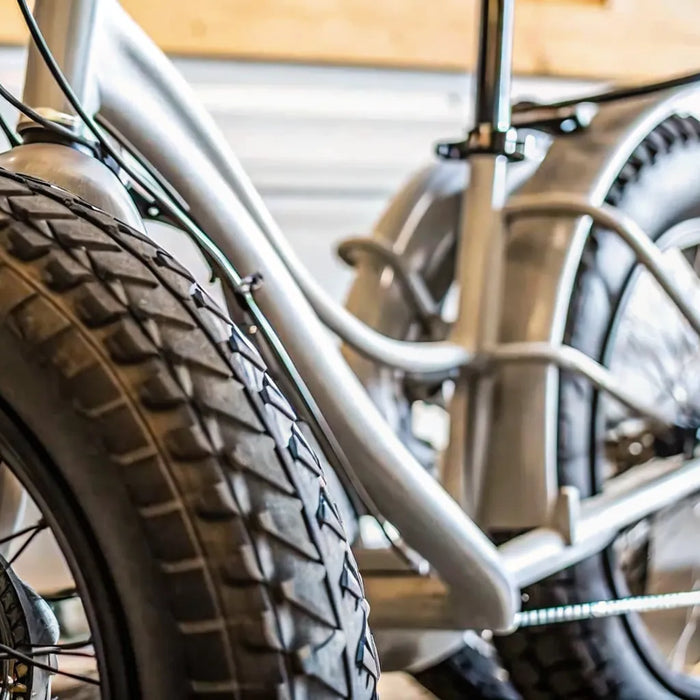 Electric fat tire tricycle for adults with thick all-terrain tires and a sturdy frame.