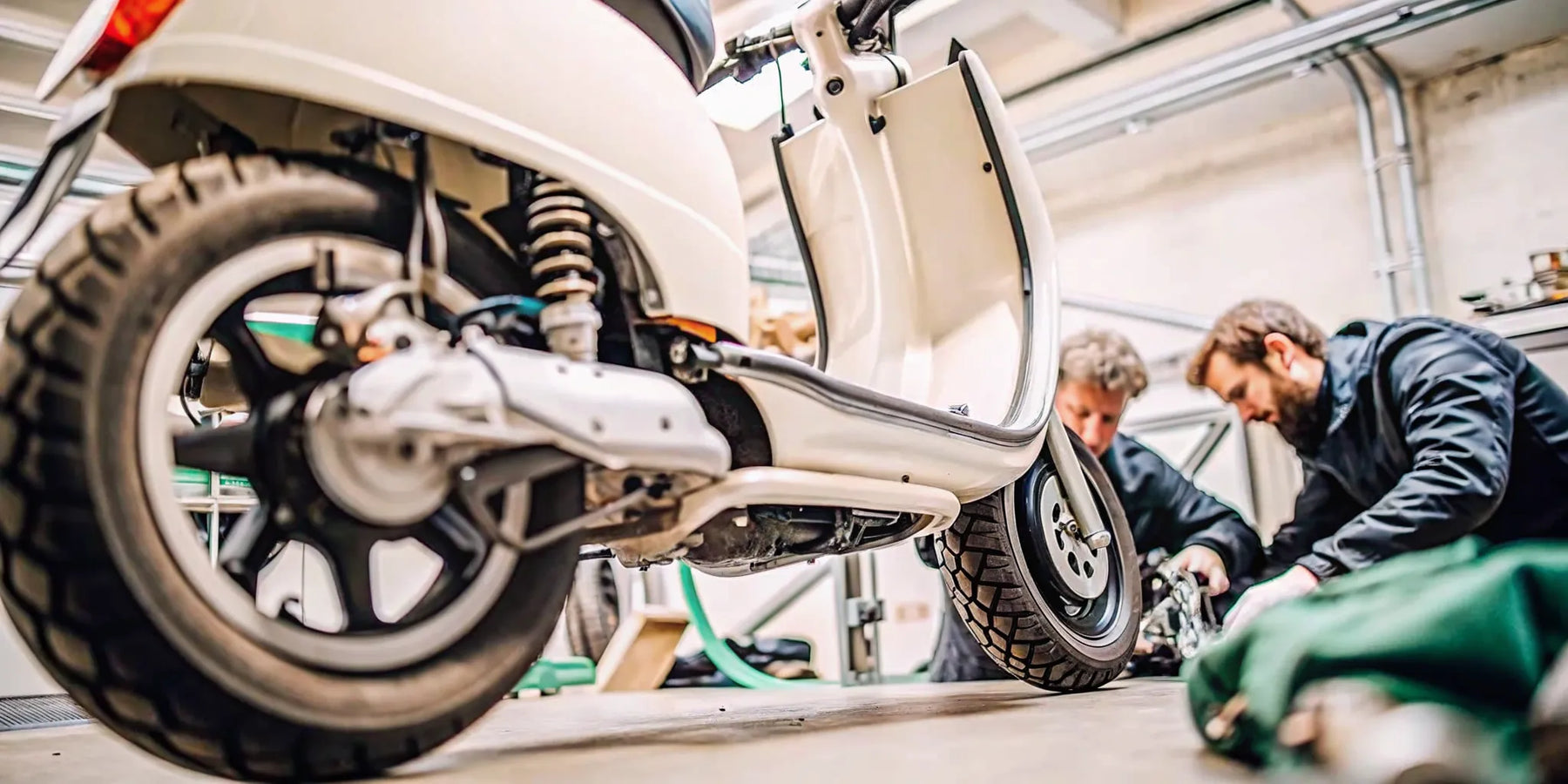 Electric scooter undergoing professional repair in a workshop