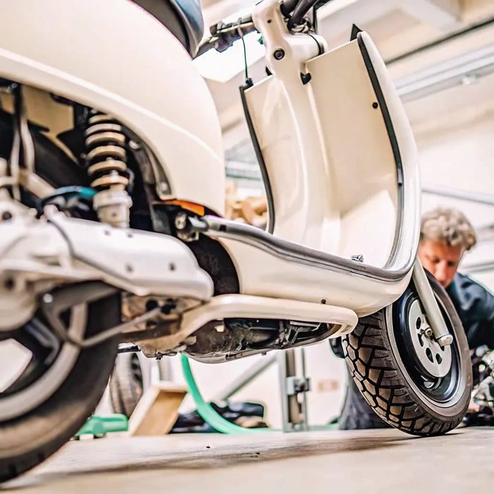 Electric scooter undergoing professional repair in a workshop