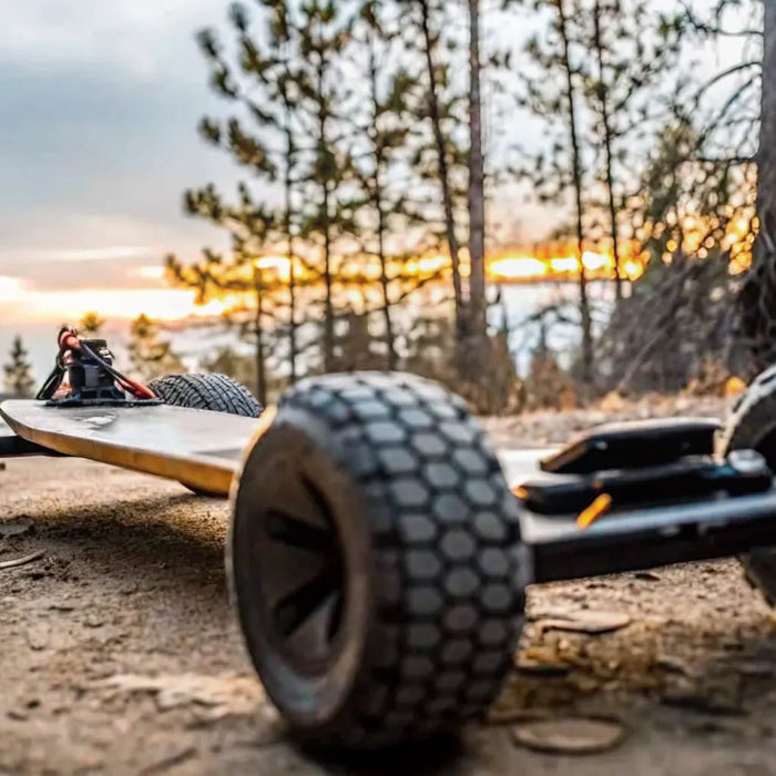A high-performance off-road electric skateboard on a rugged trail in Bend Oregon during sunset