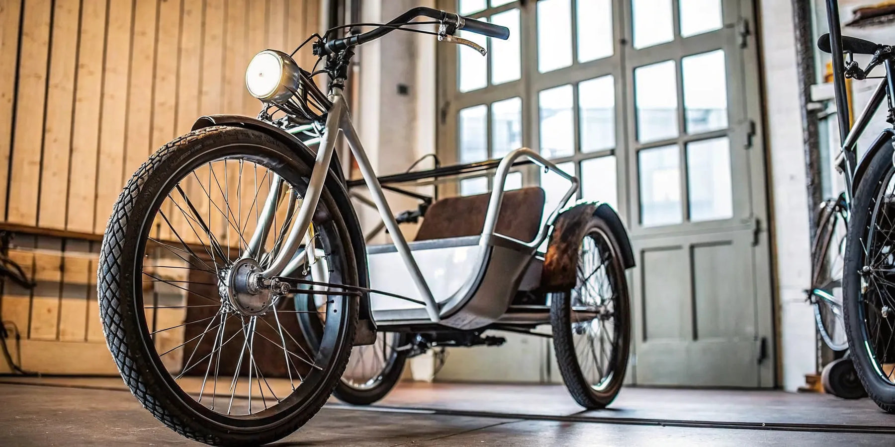 A stable electric tricycle with a comfortable rear passenger seat.