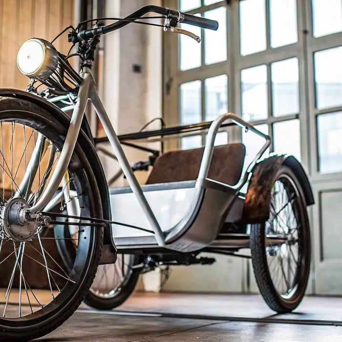 A stable electric tricycle with a comfortable rear passenger seat.