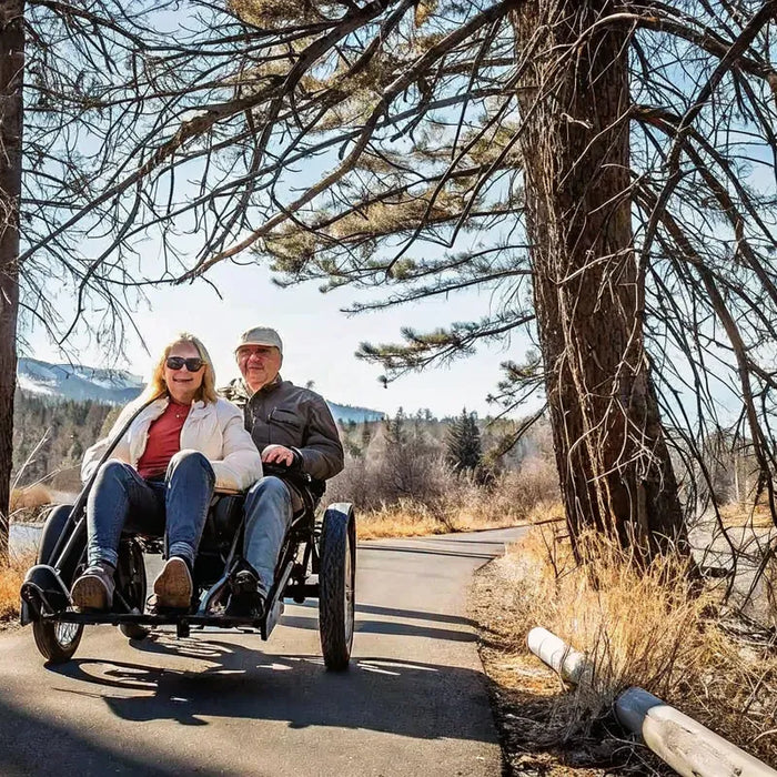 A couple riding an electric trike together on a paved trail near Bend, Oregon