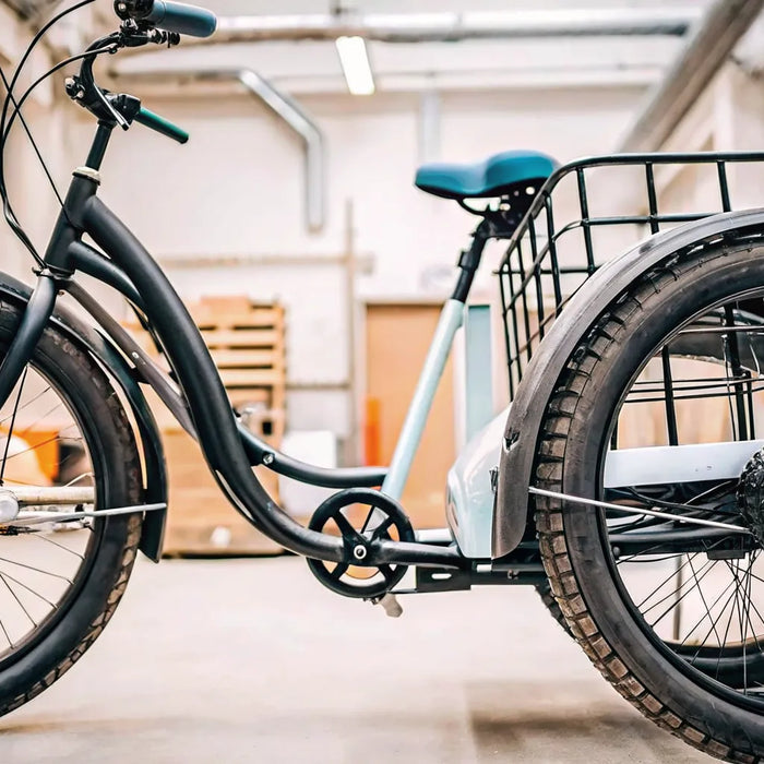 A fat tire electric trike for sale, featuring a sturdy frame and large cargo basket.