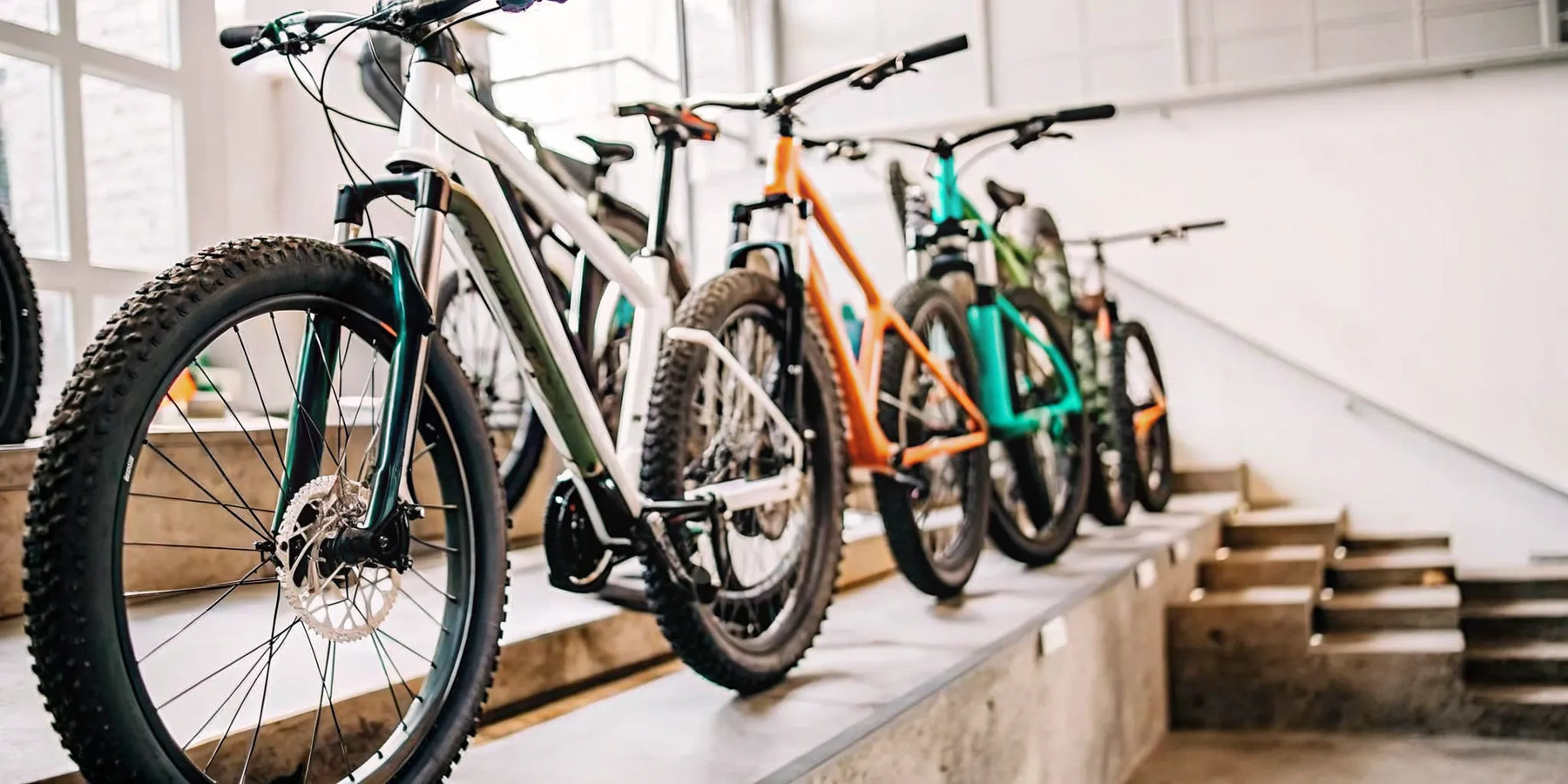 Top-rated electric mountain bikes on display in a shop for review and comparison.