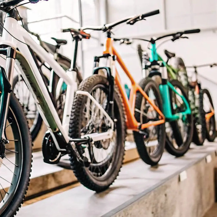 Top-rated electric mountain bikes on display in a shop for review and comparison.