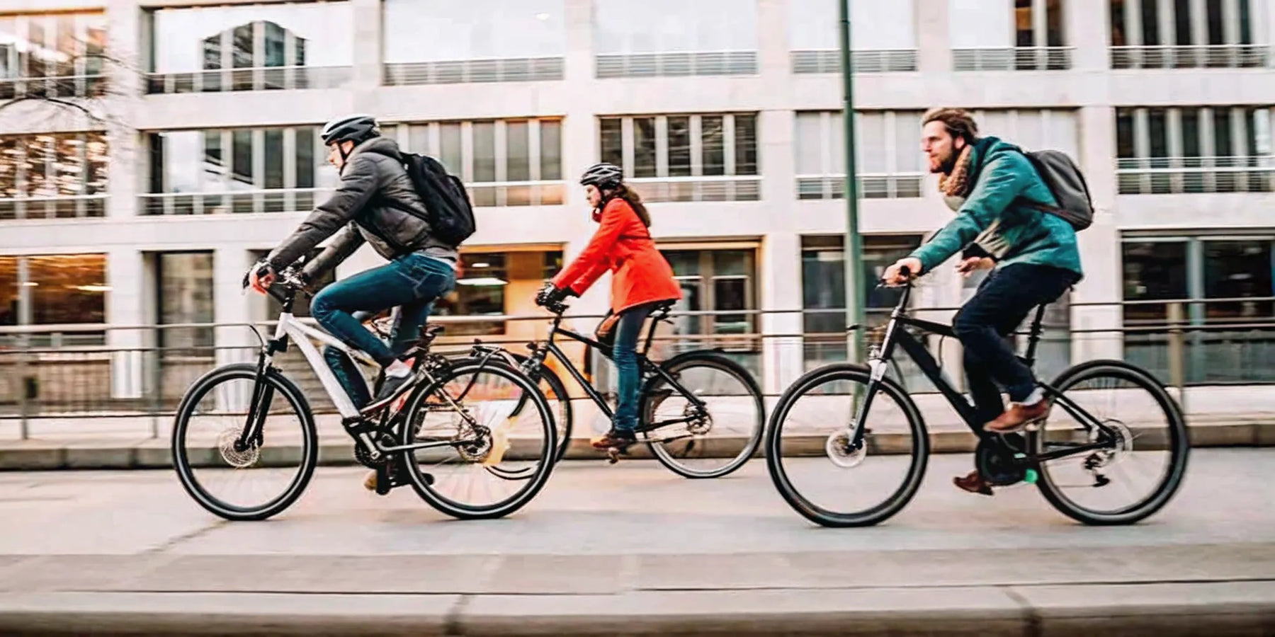 Three people on different e-bike models and classes comparing their top speeds in the city.