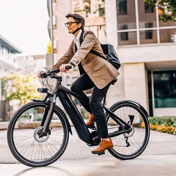 A person commuting on a fast electric bike through a city.