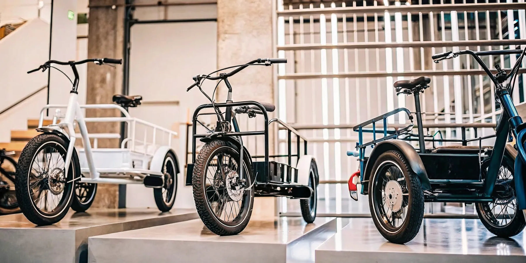 A row of electric trikes with different price points and features.