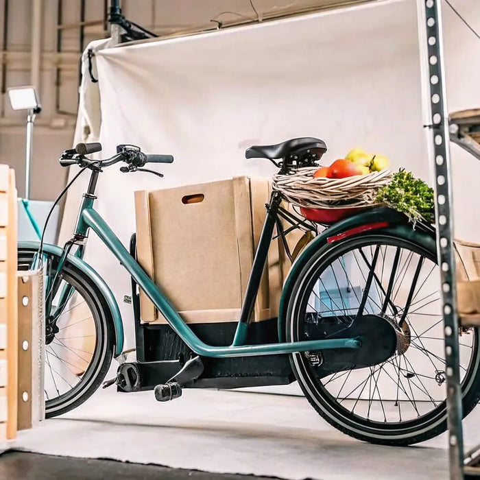 An electric cargo bike carrying a heavy load of groceries and boxes.