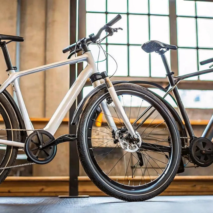 An e-bike with a central mid-drive motor next to an e-bike with a rear hub motor.