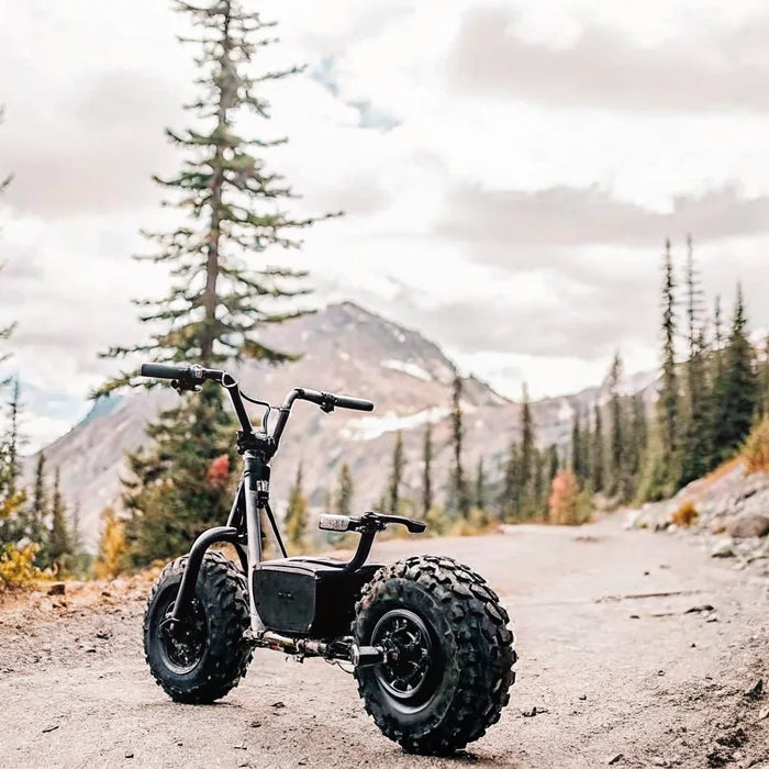 Segway Xaber 300 electric dirt bike on a rugged Oregon off-road trail with pine trees and mountains in the background