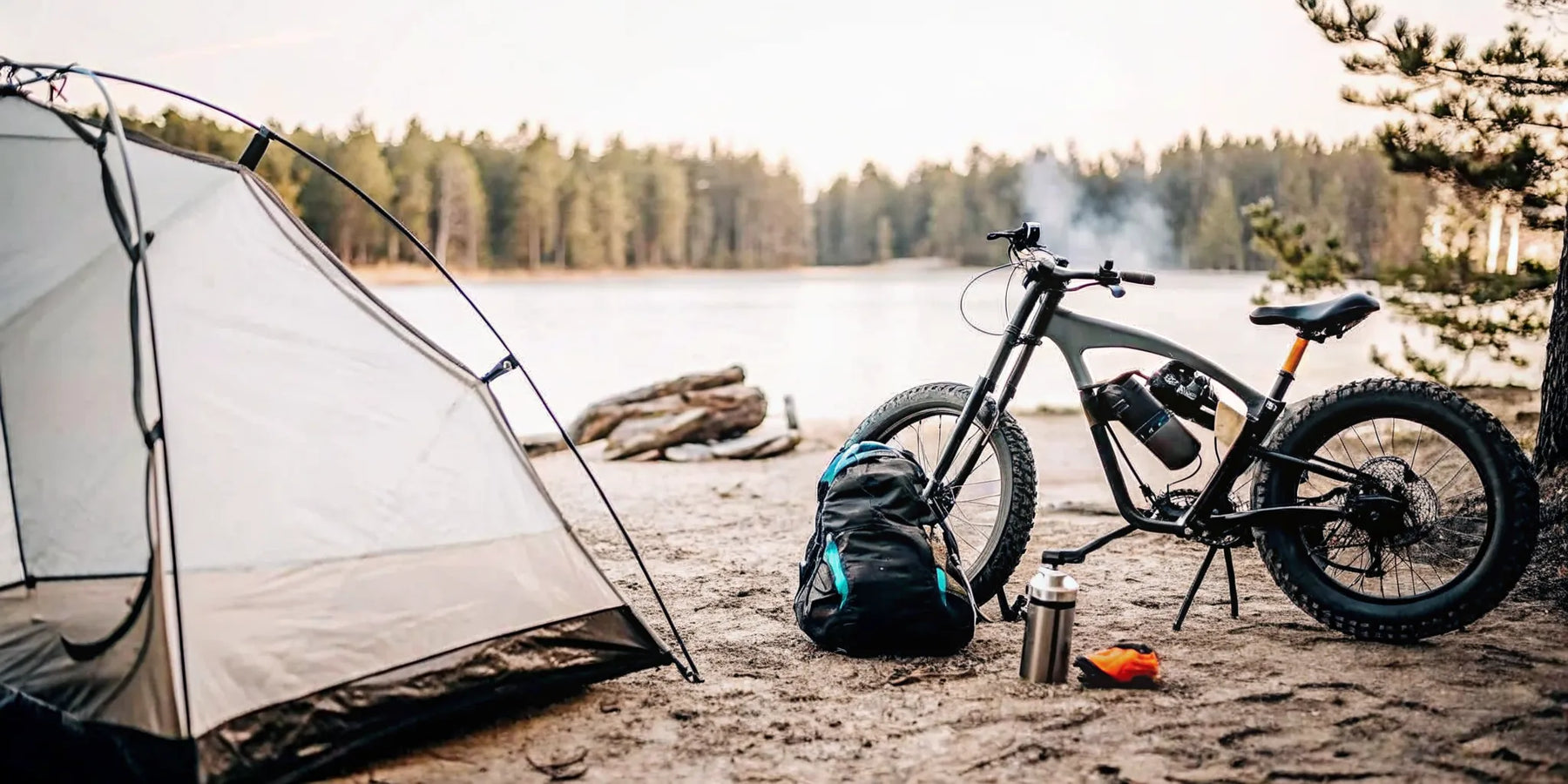 Segway Xaber 300 electric dirt bike for camping, parked at a lakeside site.