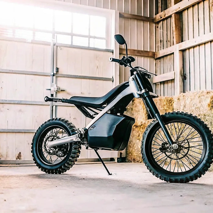 Segway Xaber 300 electric dirt bike for farm use parked in a barn.