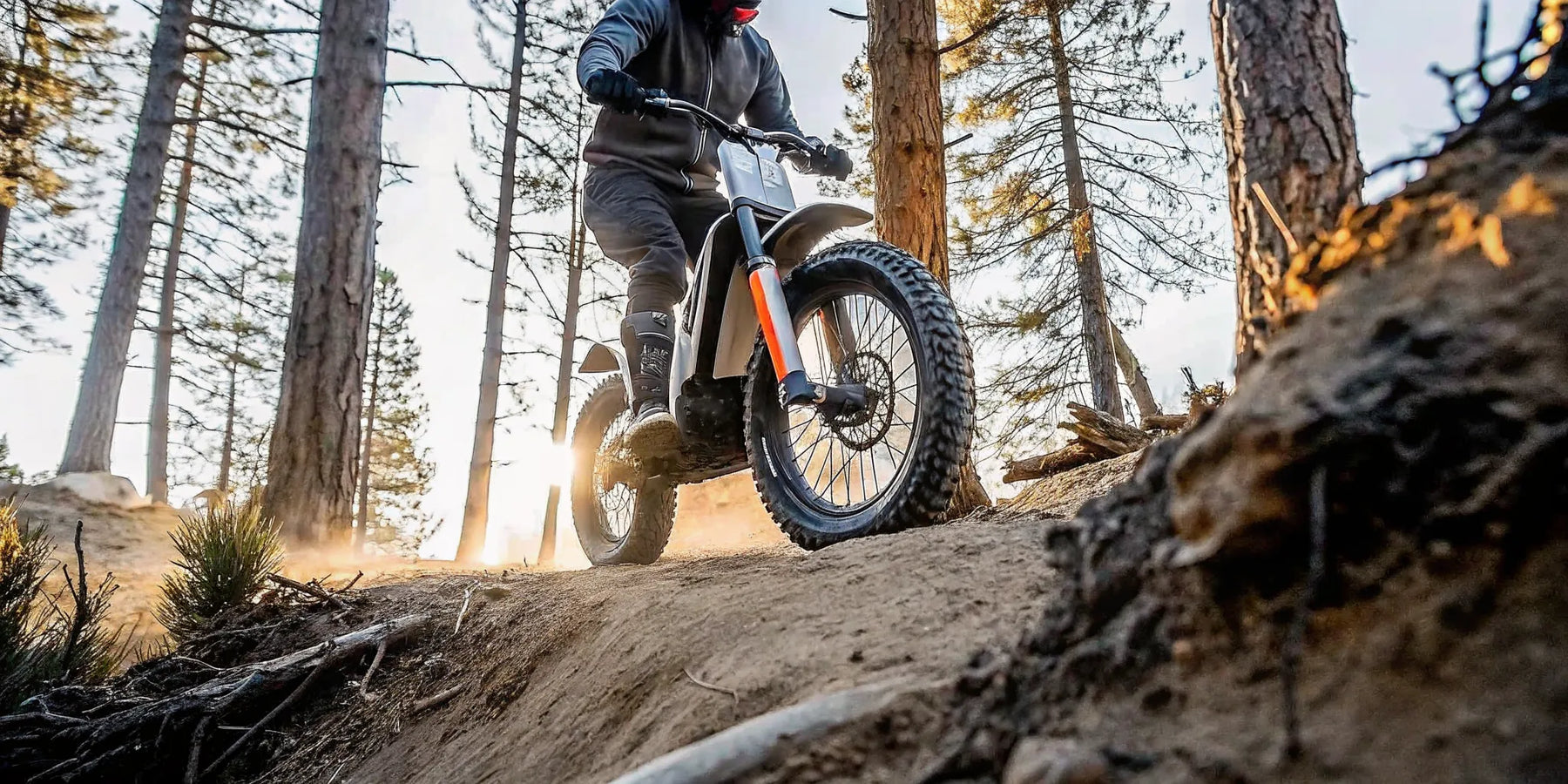 Segway Xaber 300 electric dirt bike riding on a single track through the forest.