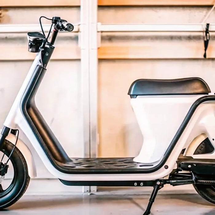 A modern commuter electric scooter parked on a city street.