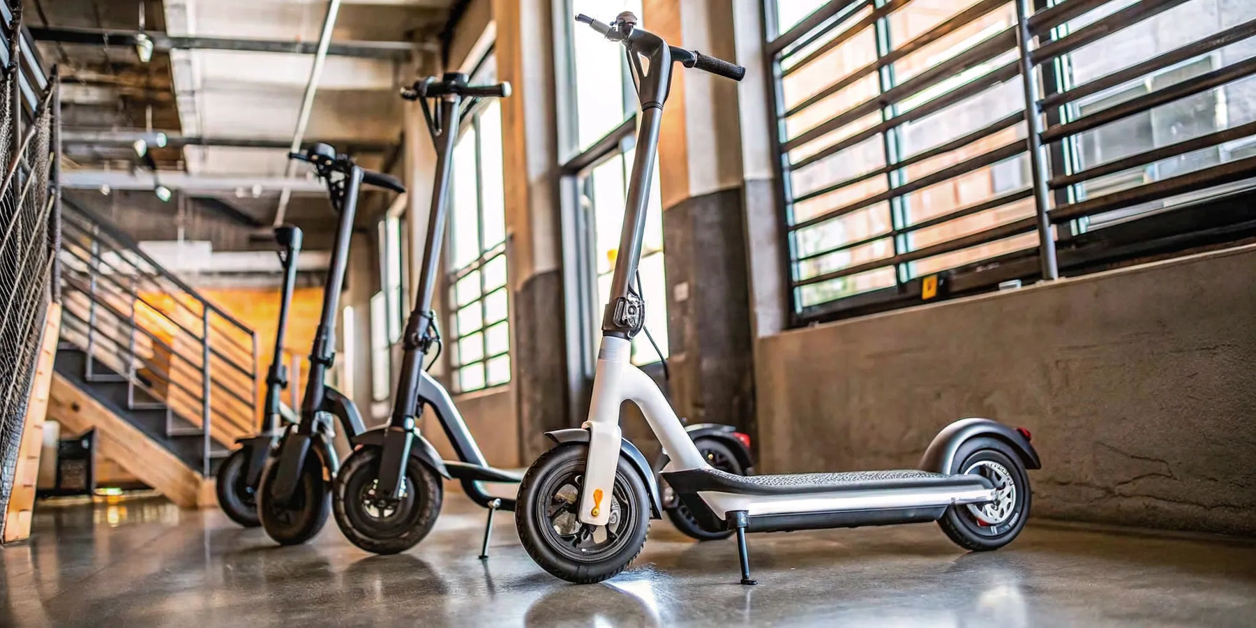 A modern seated scooter for adults with a comfortable seat, parked indoors.