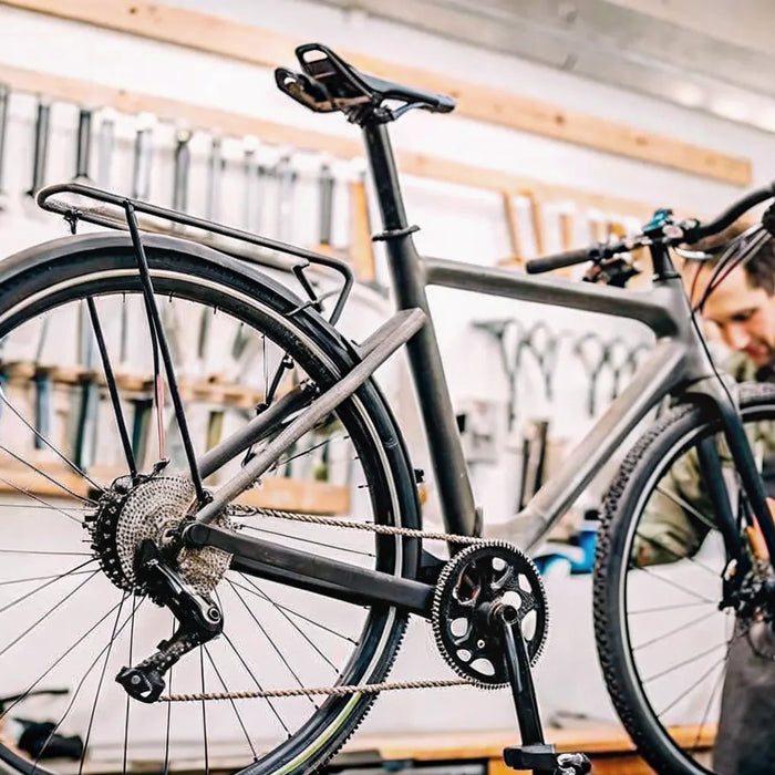 Technician performing an e-bike repair in a professional Bend workshop.