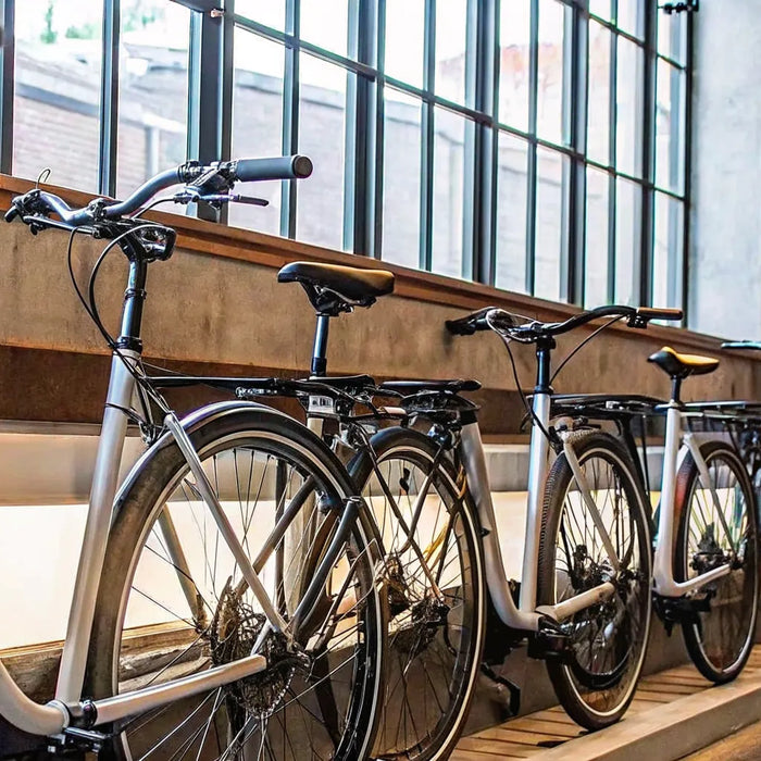 A lineup of electric bikes with 2 child seats.