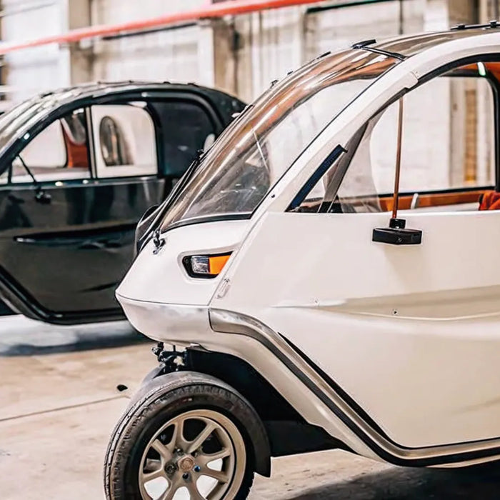 A modern enclosed electric tricycle for adults with a weather-proof cabin.