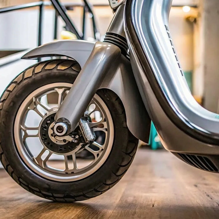 Electric scooter front wheel with a regenerative braking system that extends range.