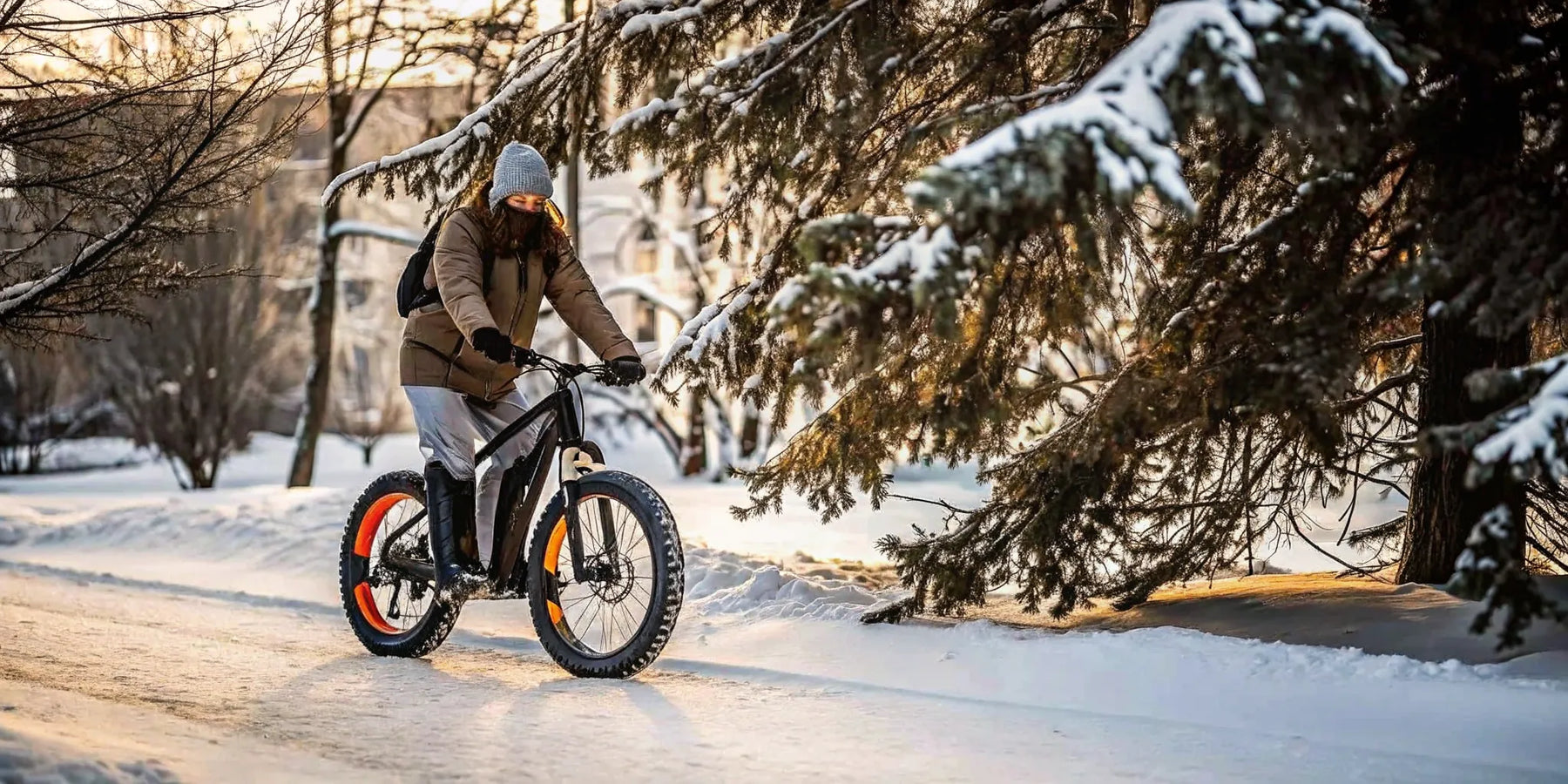 Rider on a fat-tire e-bike pedaling through fresh snow on a quiet Central Oregon street in winter