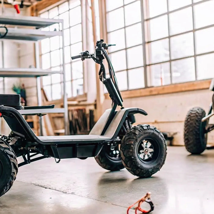 A Segway Xaber 300 electric dirt bike being serviced in a repair shop in Oregon.