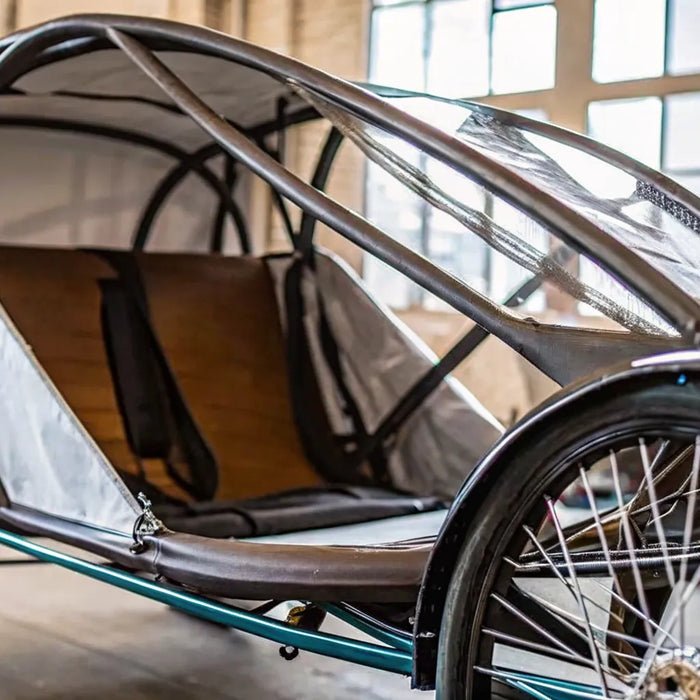 Enclosed electric recumbent trike with an aerodynamic shell for all-weather riding.